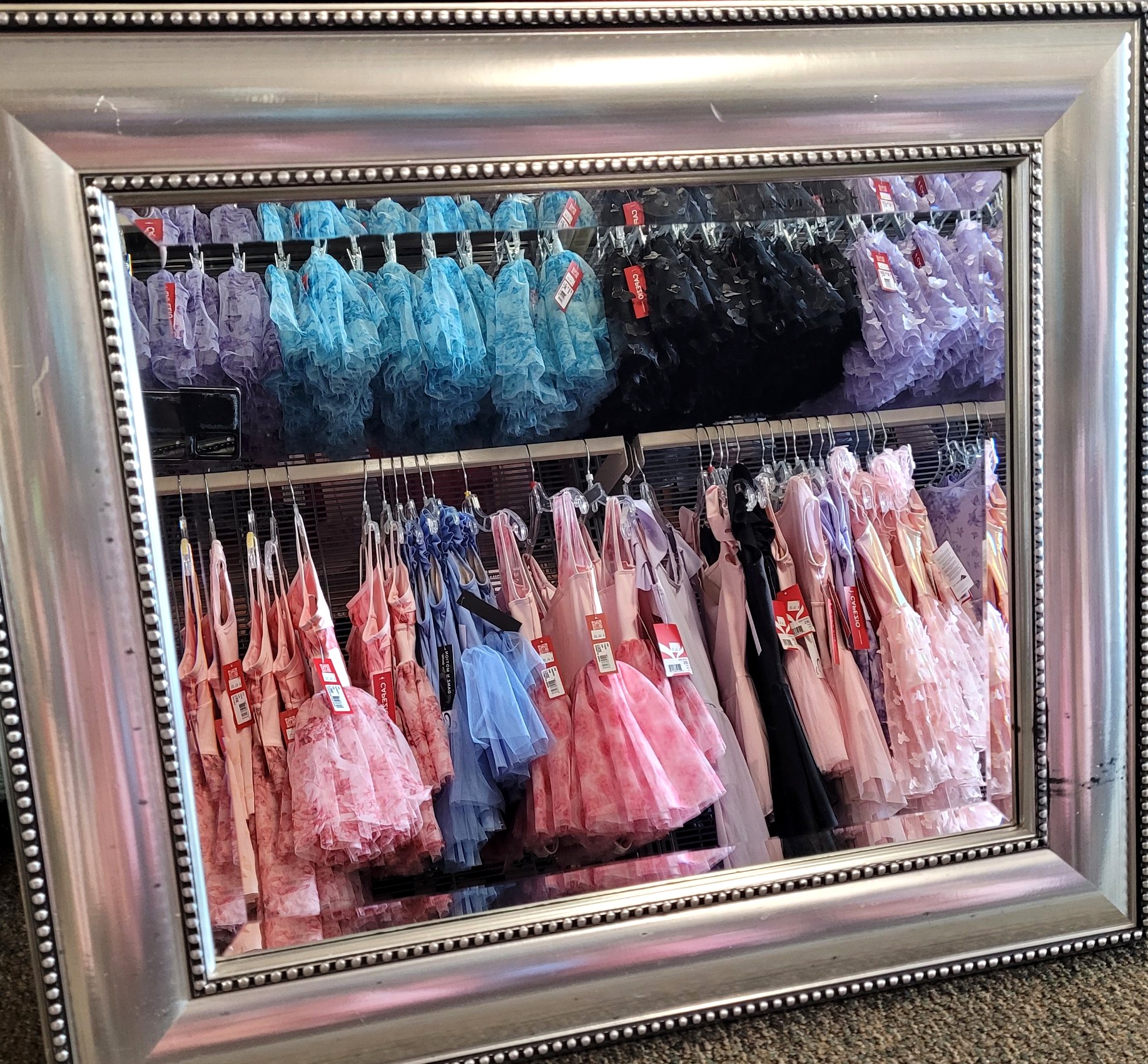 Mirror reflecting colorful leotards and tutus inside Forever Dance Apparel dance store in Grand Rapids, MI